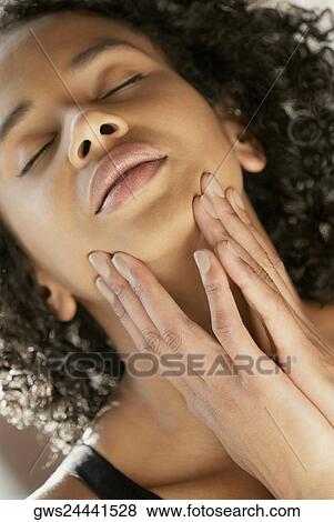 Close-up of a young woman with her eyes closed View Large Photo Image Stock Photo - Close-up of a young woman with her eyes closed. Fotosearch