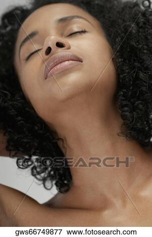 Close-up of a young woman with her eyes closed View Large Photo Image Stock Photo - Close-up of a young woman with her eyes closed. Fotosearch