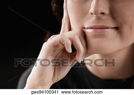 Close-up of a young woman with her hands on her head View Large Photo Image Stock Image - Close-up of a young woman with her hands on her head. Fotosearch