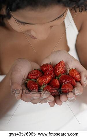 Close-up of a young woman with strawberries in her hands View Large Photo Image Stock Photography - Close-up of a young woman with strawberries in her hands. Fotosearch
