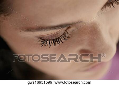 Close-up of a young woman's face View Large Photo Image Stock Photo - Close-up of a young woman's face. Fotosearch