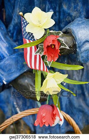 Close-up of an American flag and flowers in a statue's hand, USA View Large Photo Image Stock Photo - Close-up of an American flag and flowers in a statue's hand, USA. Fotosearch