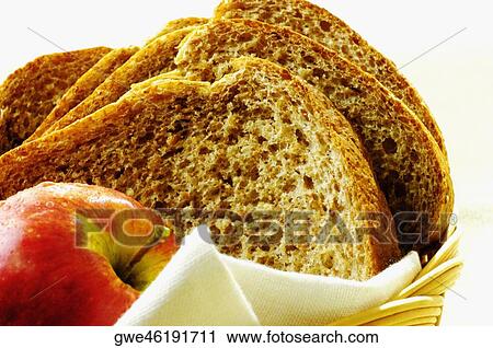 Close-up of an apple and brown bread in a basket View Large Photo Image Stock Image - Close-up of an apple and brown bread in a basket. Fotosearch