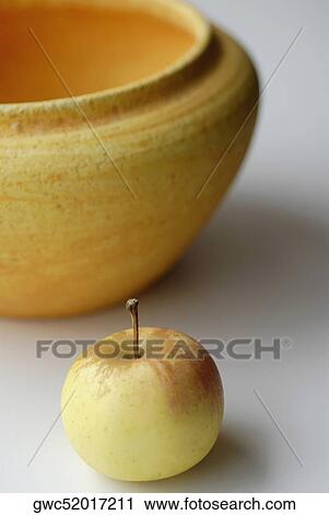 Close-up of an apple with a bowl View Large Photo Image Stock Image - Close-up of an apple with a bowl. Fotosearch