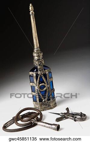 Close-up of an ornate bottle and pendant View Large Photo Image Stock Photography - Close-up of an ornate bottle and pendant. Fotosearch