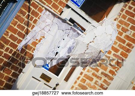 Close-up of an umbrella hanging outside a building View Large Photo Image Stock Photo - Close-up of an umbrella hanging outside a building. Fotosearch