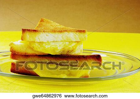Close-up of bread with cheese on a plate View Large Photo Image Stock Photograph - Close-up of bread with cheese on a plate. Fotosearch
