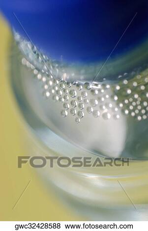 Close-up of bubbles in a water bottle View Large Photo Image Stock Photo - Close-up of bubbles in a water bottle. Fotosearch