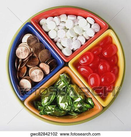 Close-up of candy and coins on a tray View Large Photo Image Stock Image - Close-up of candy and coins on a tray. Fotosearch