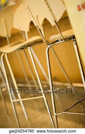 Close-up of chairs in a row View Large Photo Image Stock Image - Close-up of chairs in a row. Fotosearch