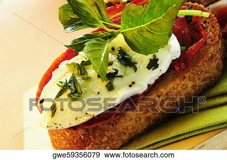 Close-up of cheese and herbs on bread View Large Photo Image Stock Photo - Close-up of cheese and herbs on bread. Fotosearch