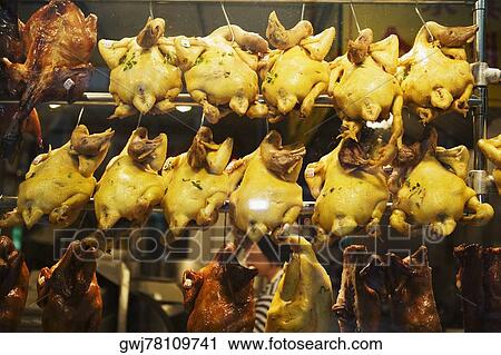 Close-up of chickens hanging in a restaurant View Large Photo Image Stock Image - Close-up of chickens hanging in a restaurant. Fotosearch