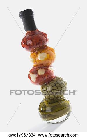 Picture - Close-up of chopped bell peppers and beans in a glass bottle. Fotosearch