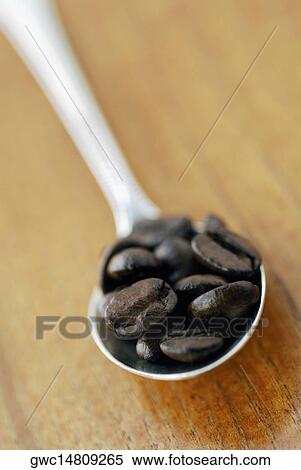 Close-up of coffee beans in a spoon View Large Photo Image Stock Photography - Close-up of coffee beans in a spoon. Fotosearch