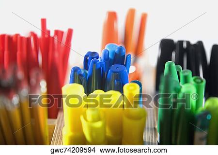 Picture - Close-up of colored pens in pen stands. Fotosearch