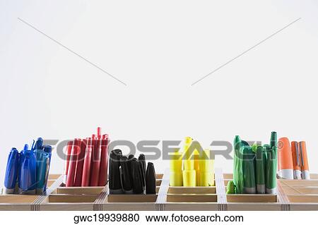 Stock Image - Close-up of colored pens in pen stands. Fotosearch