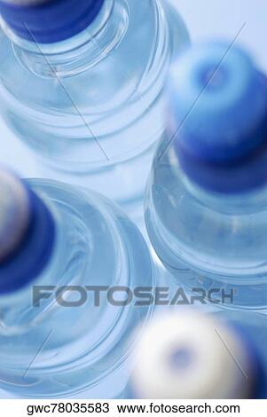 Close-up of four water bottles View Large Photo Image Stock Image - Close-up of four water bottles. Fotosearch