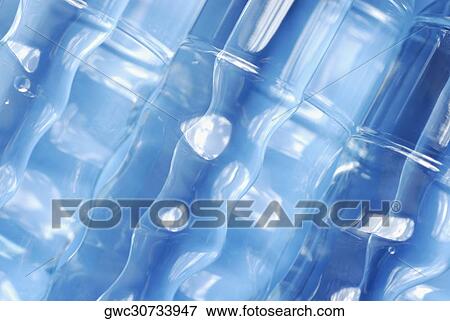 Close-up of four water bottles View Large Photo Image Stock Photo - Close-up of four water bottles. Fotosearch