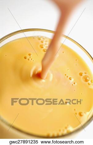 Close-up of juice being poured into a glass View Large Photo Image Stock Photography - Close-up of juice being poured into a glass. Fotosearch
