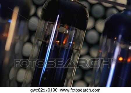 Close-up of lit up glass tube in an old fashioned radio View Large Photo Image Stock Image - Close-up of lit up glass tube in an old fashioned radio. Fotosearch