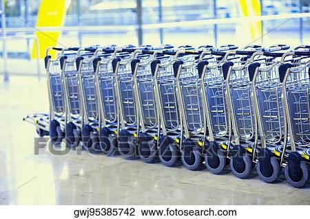 Stock Image - Close-up of luggage carts in a row. Fotosearch