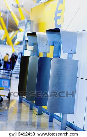 Close-up of money exchange machines at an airport, Madrid, Spain View Large Photo Image Stock Image - Close-up of money exchange machines at an airport, Madrid, Spain. Fotosearch