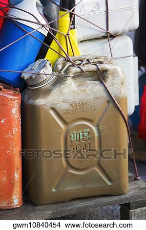 Picture - Close-up of oil cans tied up with a string. Fotosearch