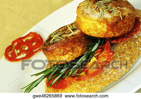 Close-up of roast meat with rosemary on a plate View Large Photo Image Stock Photo - Close-up of roast meat with rosemary on a plate. Fotosearch