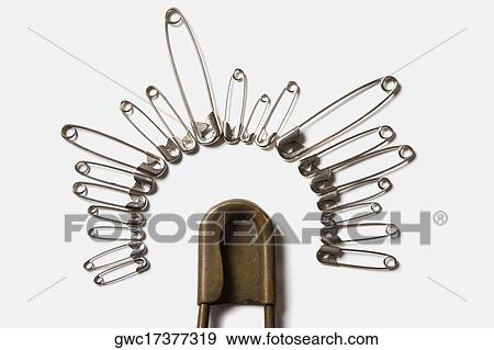 Close-up of safety pins arranged in a circle View Large Photo Image Stock Photo - Close-up of safety pins arranged in a circle. Fotosearch