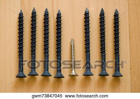 Stock Photography - Close-up of screws arranged in a row. Fotosearch