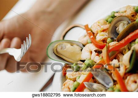 Close-up of seafood with rice and green peas in a pan View Large Photo Image Stock Photography - Close-up of seafood with rice and green peas in a pan. Fotosearch