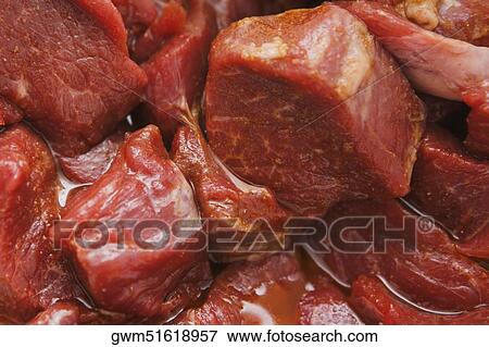 Stock Photo - Close-up of slices of raw meat. Fotosearch