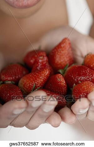 Close-up of strawberries in a young woman's hands View Large Photo Image Stock Photo - Close-up of strawberries in a young woman's hands. Fotosearch