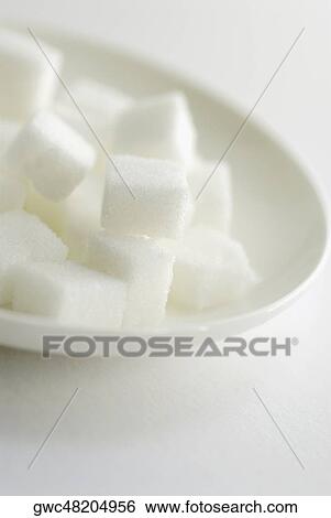 Close-up of sugar cubes in a plate View Large Photo Image Stock Photograph - Close-up of sugar cubes in a plate. Fotosearch