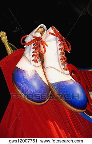 Stock Image - Close-up of the sculpture of a pair of clown shoes. Fotosearch