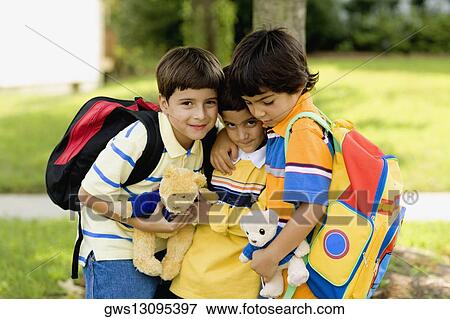 Close-up of three schoolboys standing together View Large Photo Image Stock Photo - Close-up of three schoolboys standing together. Fotosearch
