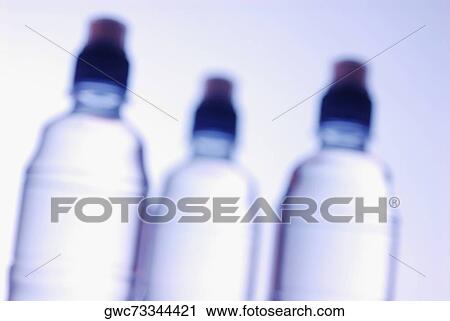 Stock Image - Close-up of three water bottles. Fotosearch
