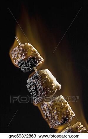 Close-up of toasted marshmallows on a skewer View Large Photo Image Stock Image - Close-up of toasted marshmallows on a skewer. Fotosearch