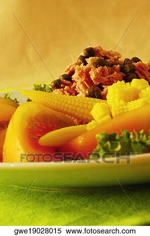 Stock Photography - Close-up of tomato slices and baby corn on a plate. Fotosearch