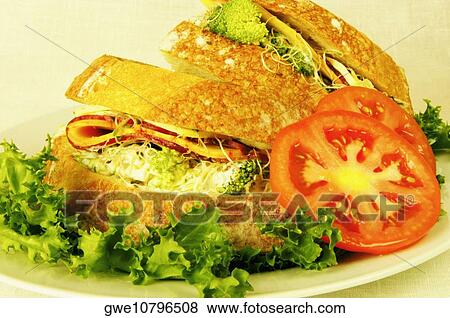 Close-up of tomato slices with sandwiches on a plate View Large Photo Image Stock Photo - Close-up of tomato slices with sandwiches on a plate. Fotosearch
