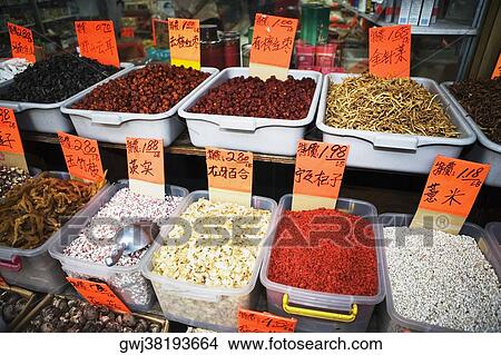 Picture - Close-up of tubs of spices with dry fruits and dry fishes. Fotosearch