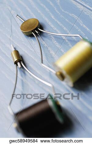 Picture - Close-up of two bobbin holders. Fotosearch