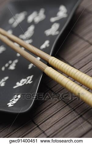 Close-up of two chopsticks and a tray View Large Photo Image Stock Image - Close-up of two chopsticks and a tray. Fotosearch