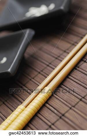 Close-up of two chopsticks on a mat View Large Photo Image Stock Image - Close-up of two chopsticks on a mat. Fotosearch