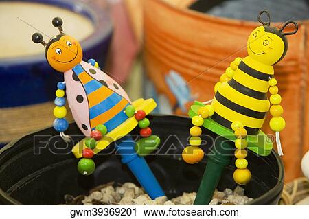Close-up of two dolls with pebbles in a container View Large Photo Image Stock Image - Close-up of two dolls with pebbles in a container. Fotosearch