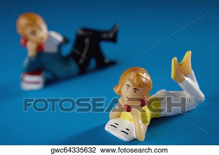 Close-up of two figurines View Large Photo Image Stock Image - Close-up of two figurines. Fotosearch