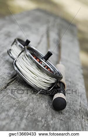 Close-up of two fishing reels and a fishing rod View Large Photo Image Stock Image - Close-up of two fishing reels and a fishing rod. Fotosearch