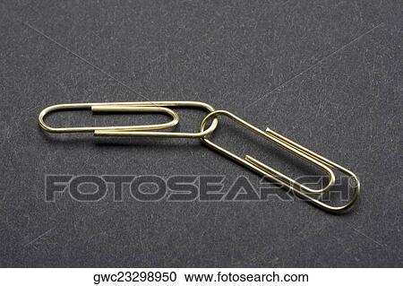 Close-up of two interlocked paper clips View Large Photo Image Stock Image - Close-up of two interlocked paper clips. Fotosearch