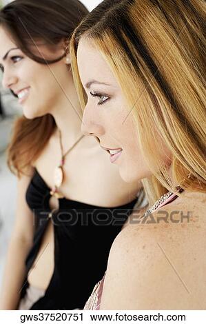 Close-up of two young women smiling View Large Photo Image Stock Image - Close-up of two young women smiling. Fotosearch