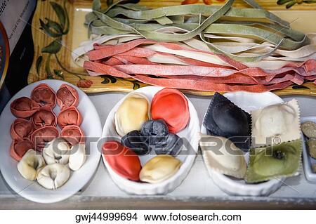 Close-up of uncooked assorted pastas and dumplings in trays View Large Photo Image Picture - Close-up of uncooked assorted pastas and dumplings in trays. Fotosearch